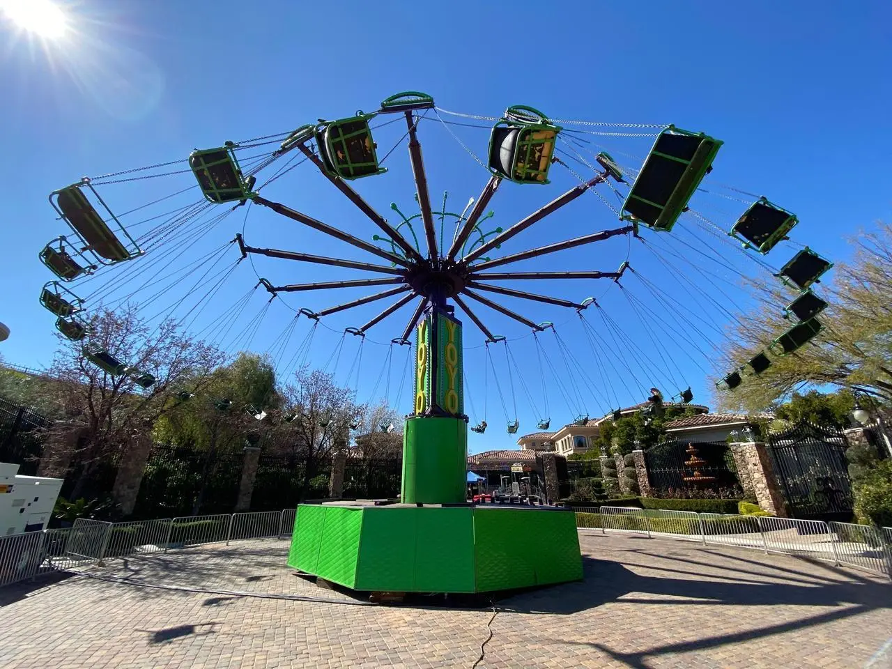 YoYo Swing Ride Green Base Yellow Green Column Outdoor Event Production Las Vegas