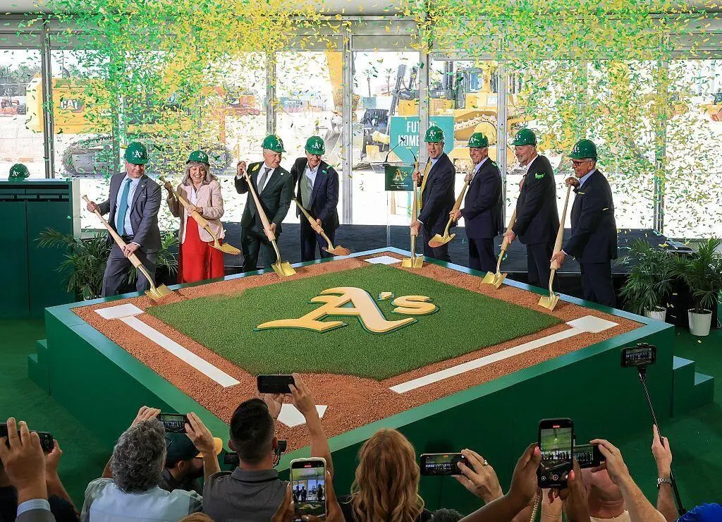 Groundbreaking ceremony with A's logo, golden shovels, construction site