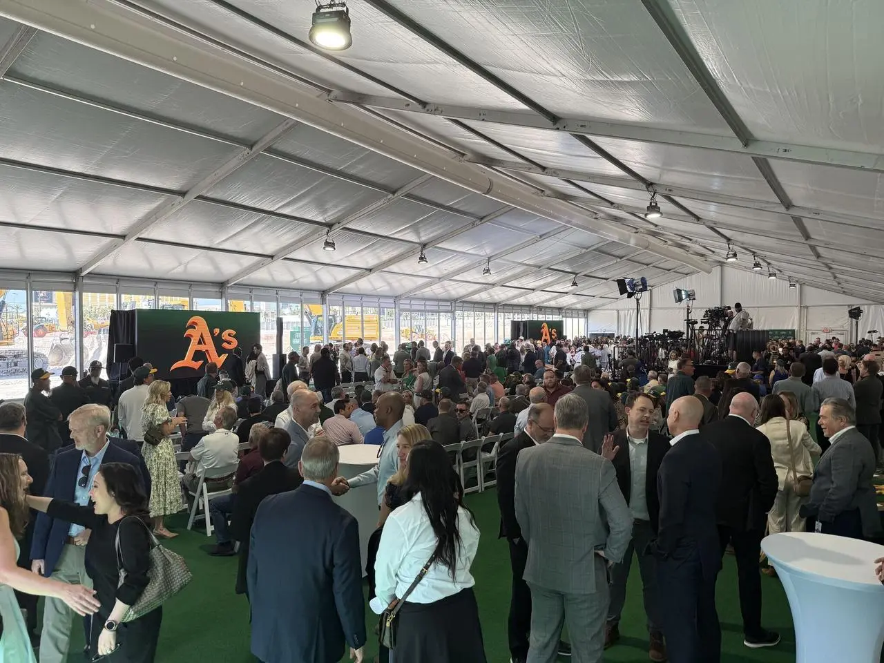 Oakland Athletics groundbreaking ceremony tent interior with stage and media setup in Las Vegas